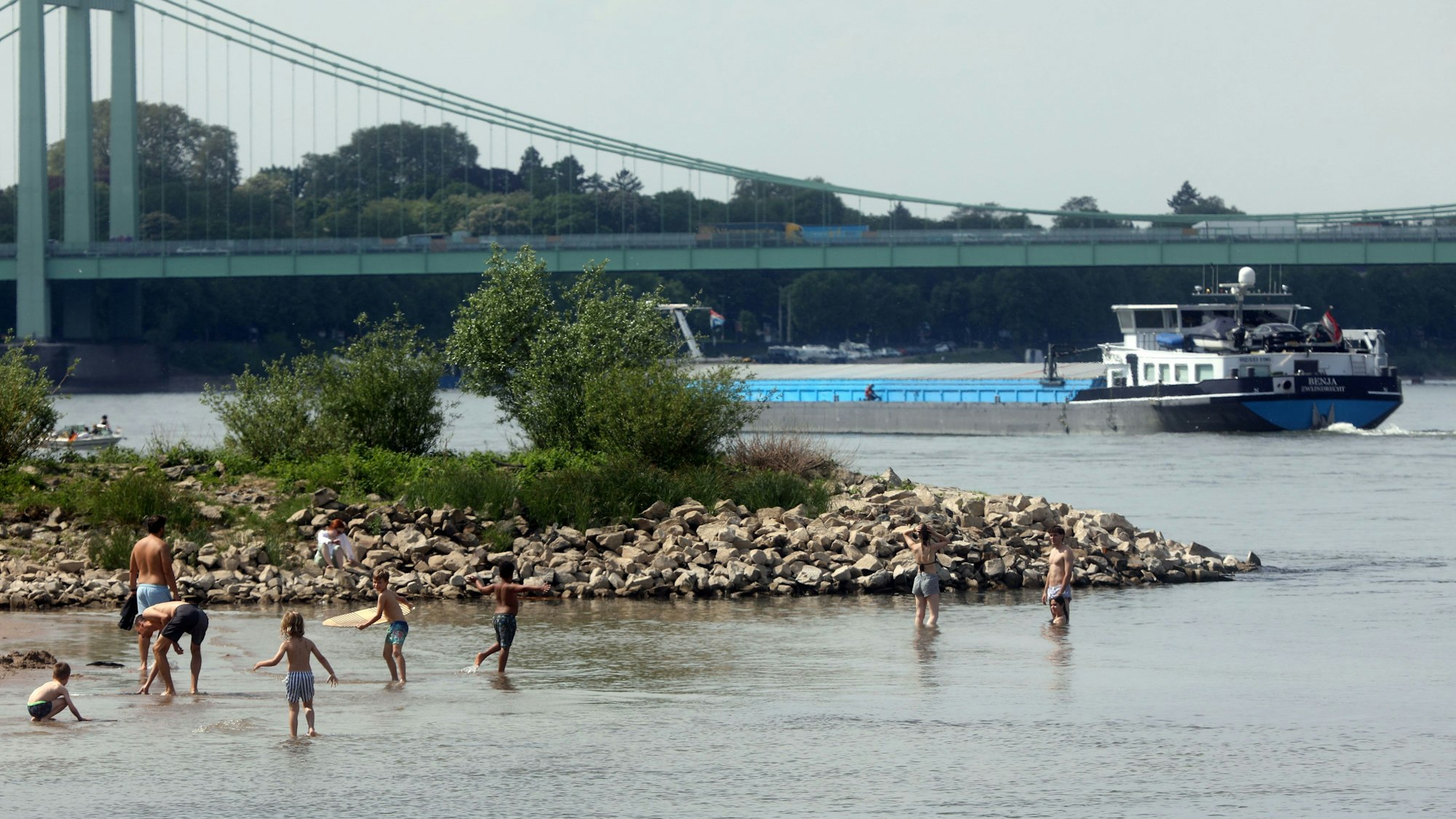 02.04.2025, Köln: Das sommerliche Wetter lockt die Kölnerin und Kölner an den Rhein am Ufer in Rodenkirchen. Die Gefahr: die Strömung und die Tiefe des Flusses. Foto: Arton Krasniqi
