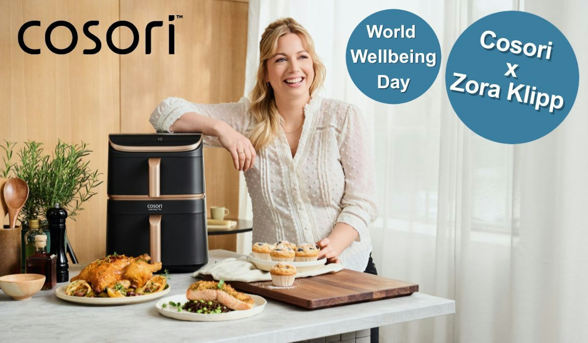 Zora Klipp lächelt neben dem Cosori Airfryer, umgeben von gesunden Gerichten aus dem Airfryer.