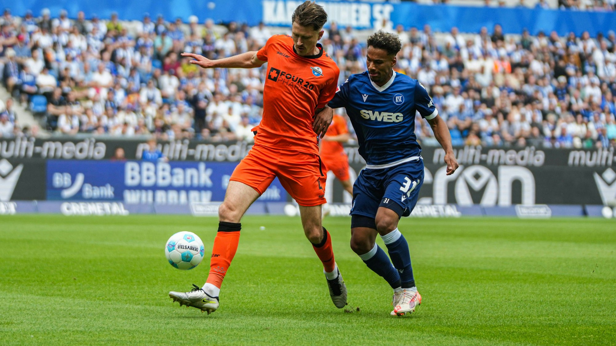 Paderborns Calvin Brackelmann im Zweikampf mit Bambasé Conté vom Karlsruher SC.