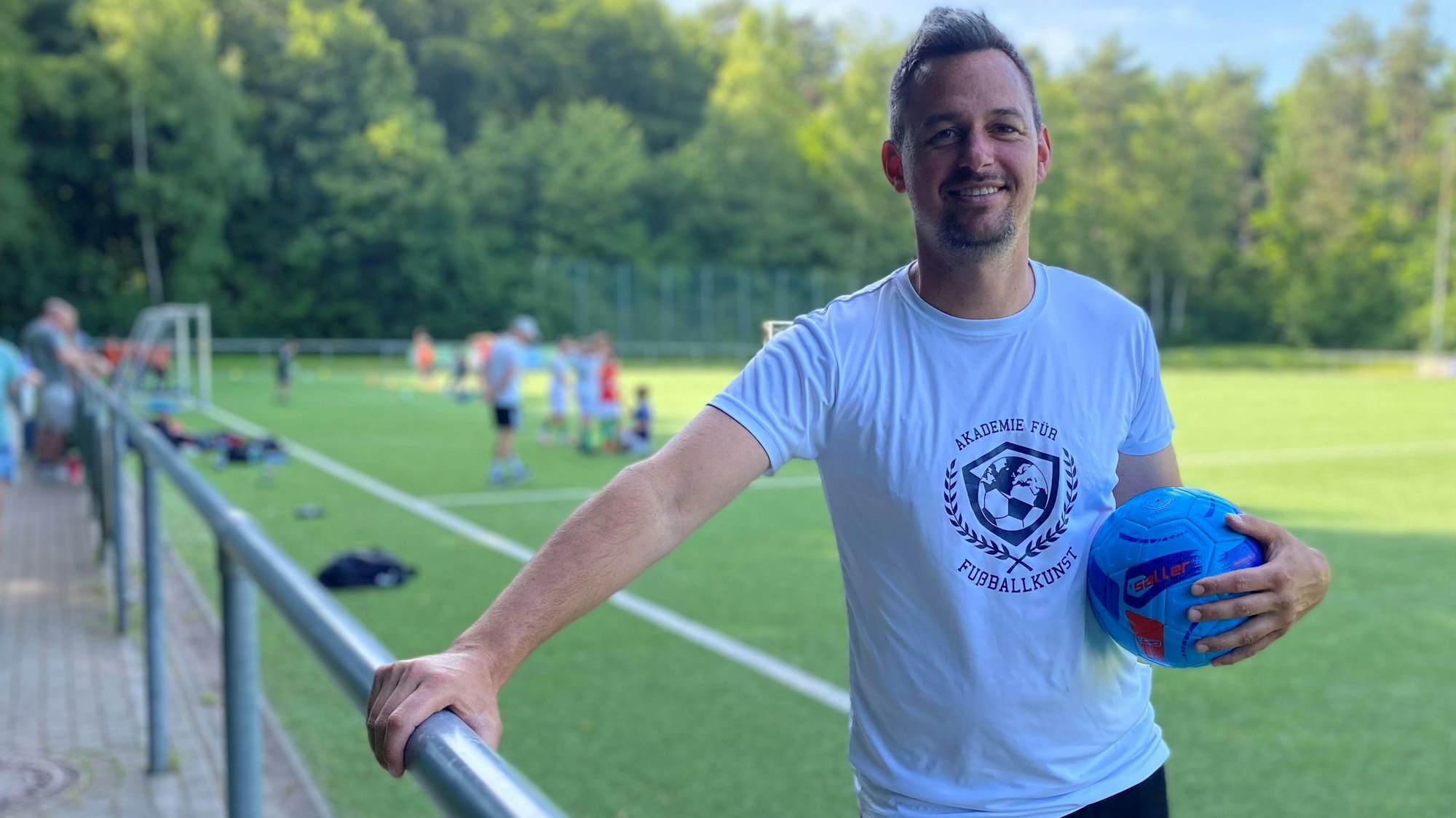 Zu sehen ist Yaschar Hayitt. Er hält einen Fußball in der Hand.