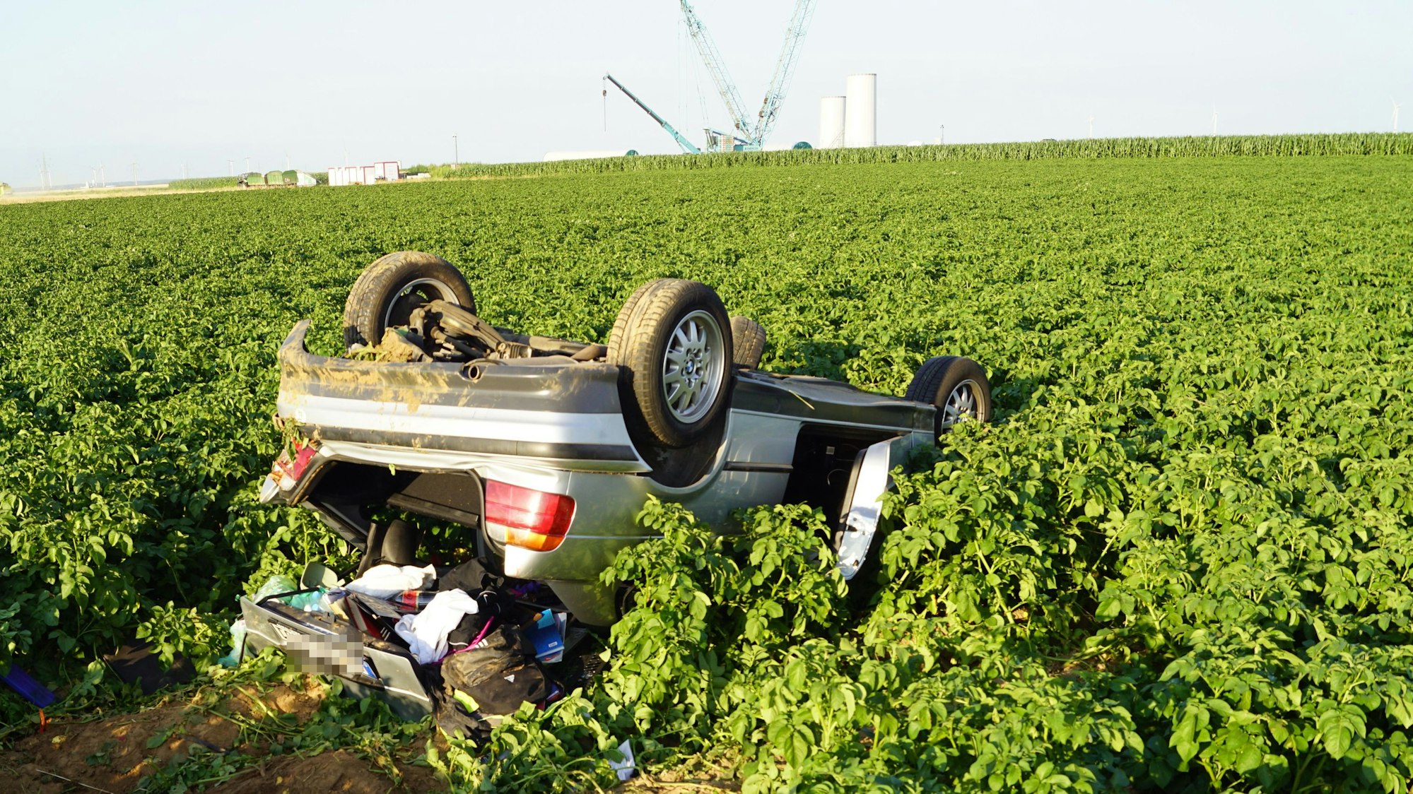 Das Bild zeigt das Auto, wie es nach dem Unfall im Feld liegt. Es ist auf dem Dach liegengeblieben.