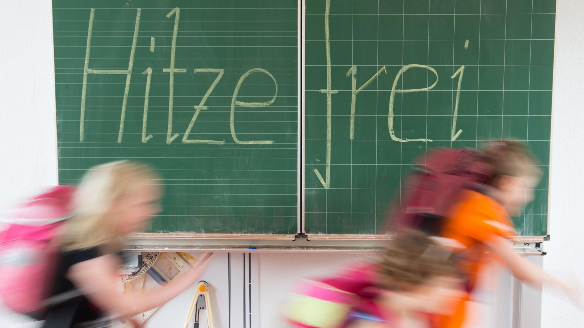 ARCHIV - 30.06.2015, Sachsen, Dresden: ILLUSTRATION - Schüler einer 2. Klasse laufen in einer Grundschule an einer Tafel mit der Aufschrift "Hitzefrei" vorbei.
Hitzefrei - das wünschen sich wohl fast alle Schüler, wenn es heiß wird. Foto: Sebastian Kahnert/dpa-Zentralbild/dpa - ACHTUNG: Dieses Foto hat dpa bereits im Bildfunk gesendet - Honorarfrei nur für Bezieher des Dienstes dpa-Nachrichten für Kinder +++ dpa-Nachrichten für Kinder +++ | Verwendung weltweit