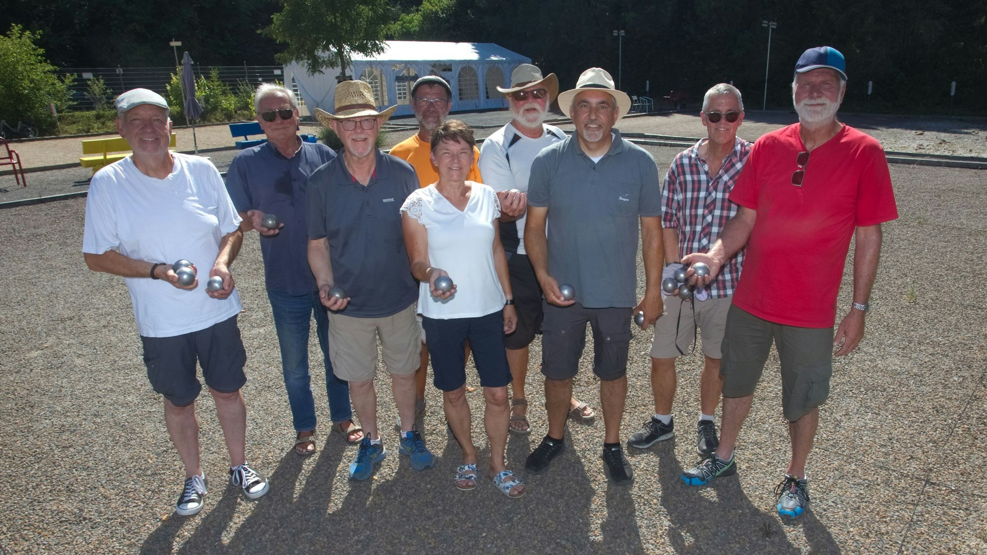Zu sehen ist eine Gruppen von Menschen auf einem Petanque-Platz.