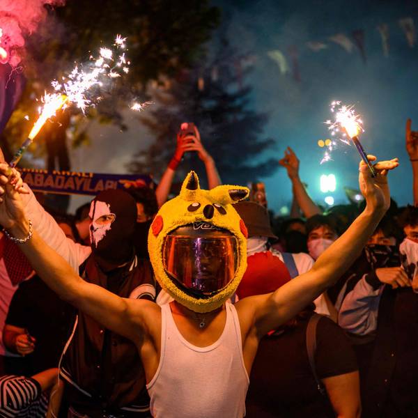 A protester in a pikachu hat holds a firecracker during a rally protesting the 100th day of the detention of Istanbul Mayor Ekrem Imamoglu, at Sarachane Square in Istanbul, on July 1, 2025. (Photo by Yasin AKGUL / AFP)