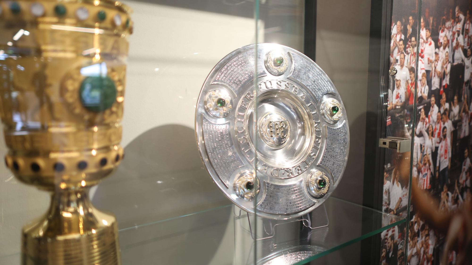 Blick auf DFB-Pokal und Meisterschale in einer Vitrine im Restaurant.