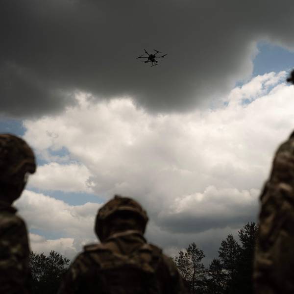 Soldiers from the "Black Sky" battalion of the Spartan brigade look at an agricultural drone, transformed into a front-line delivery cargo, during a demonstration for AFP, at an undisclosed location not far from the front line, in the region of Dnipropetrovsk, Ukraine, on June 14, 2025, amid the russian invasion of Ukraine. Ukrainian army logistics have become the priority target for Russian drones. The technological and financial growth of the Russian drone industry is forcing the Ukrainian army to adapt by building new means of transport and logistical deliveries, such as buggies, motorbikes and cargo delivery drones, using whatever resources are available. (Photo by Florent VERGNES / AFP)