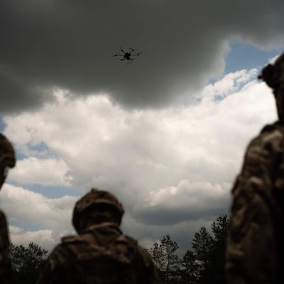 Soldiers from the "Black Sky" battalion of the Spartan brigade look at an agricultural drone, transformed into a front-line delivery cargo, during a demonstration for AFP, at an undisclosed location not far from the front line, in the region of Dnipropetrovsk, Ukraine, on June 14, 2025, amid the russian invasion of Ukraine. Ukrainian army logistics have become the priority target for Russian drones. The technological and financial growth of the Russian drone industry is forcing the Ukrainian army to adapt by building new means of transport and logistical deliveries, such as buggies, motorbikes and cargo delivery drones, using whatever resources are available. (Photo by Florent VERGNES / AFP)