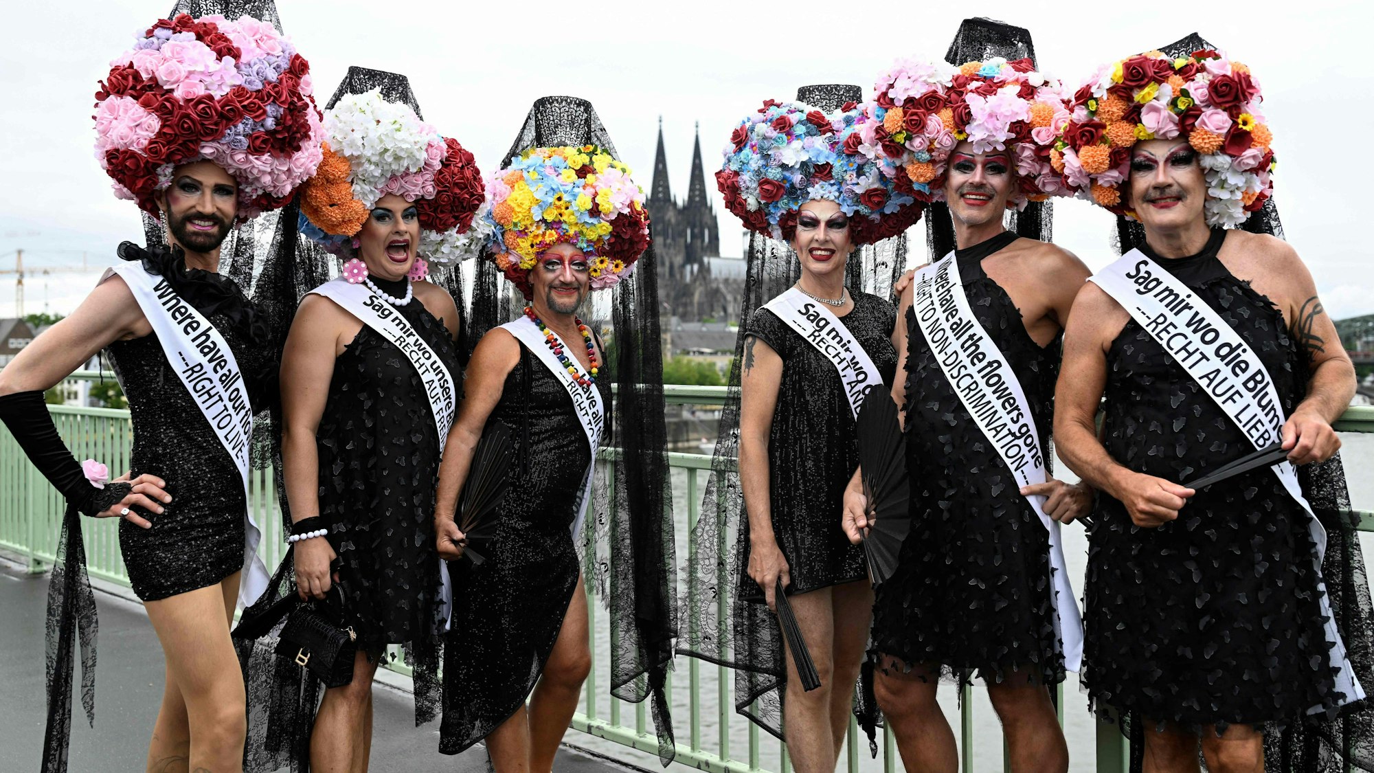 Revellers in costumes pose as they arrive to take part in the Christopher Street Day (CSD) demonstration in Cologne, western Germany on July 6, 2025. The motto of this year's demonstration is "For queer rights. Many. Strong together." (Photo by INA FASSBENDER / AFP)