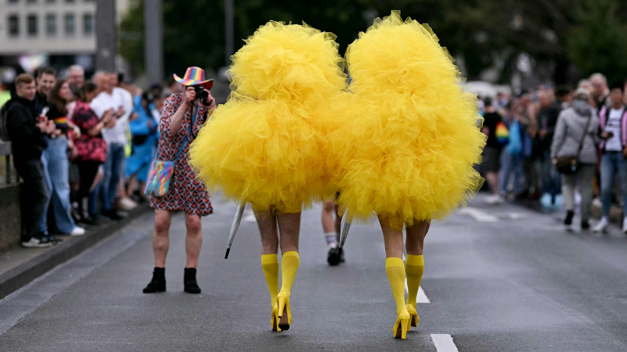 TOPSHOT - Revellers arrive to take part in the Christopher Street Day (CSD) demonstration in Cologne, western Germany on July 6, 2025. The motto of this year's demonstration is "For queer rights. Many. Strong together." (Photo by INA FASSBENDER / AFP)