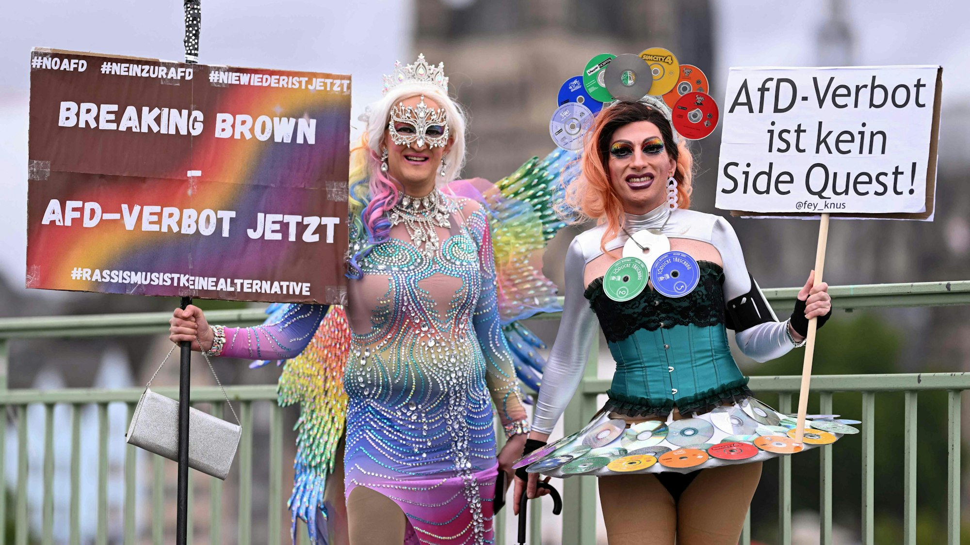 Revellers protesting with placards against far-right Alternative for Germany (AfD) party pose for photos before taking part in the Christopher Street Day (CSD) demonstration in Cologne, western Germany on July 6, 2025. The motto of this year's demonstration is "For queer rights. Many. Strong together." (Photo by INA FASSBENDER / AFP)