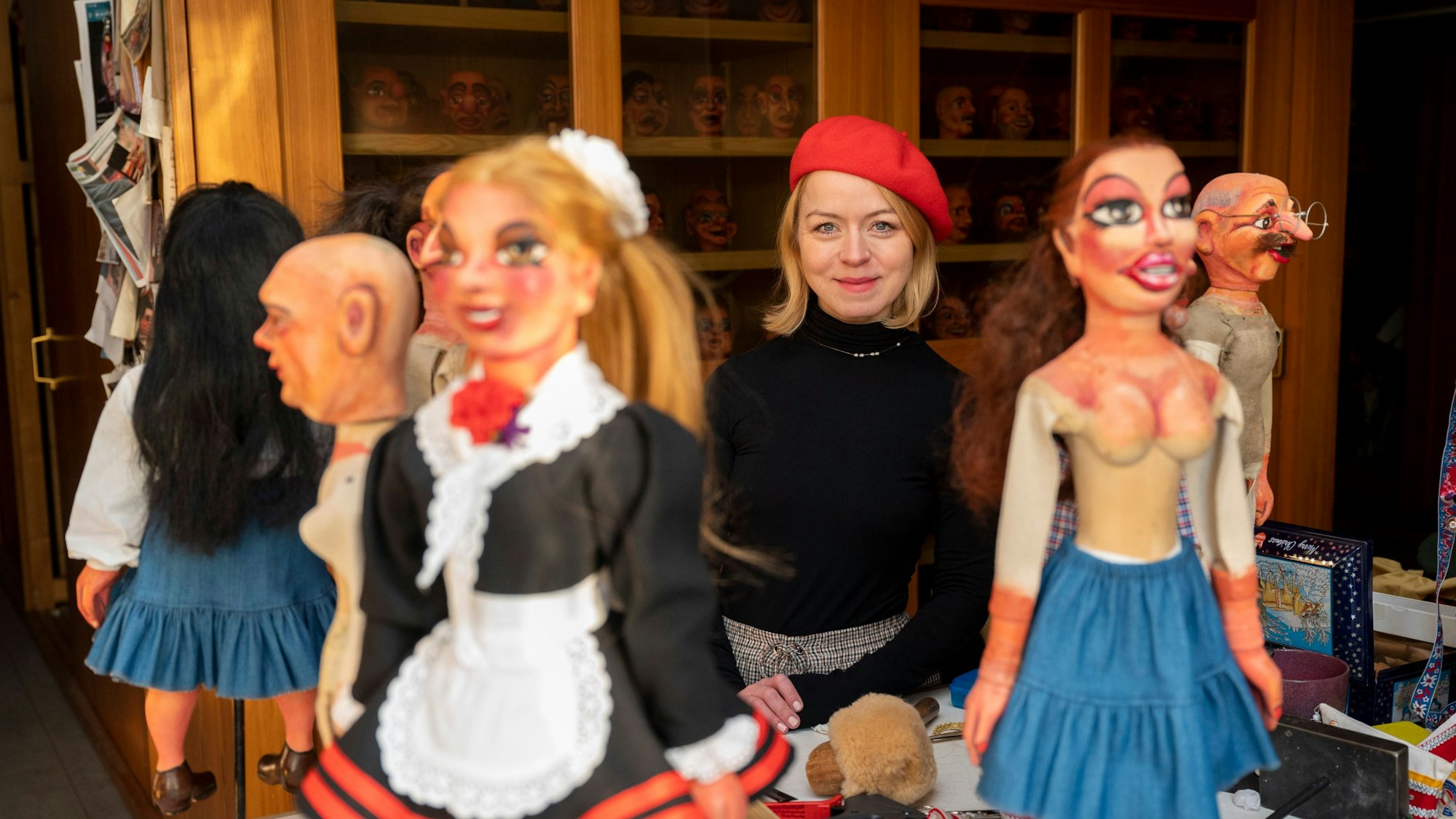 Mareike Marx ist inmitten von Marionetten zu sehen.