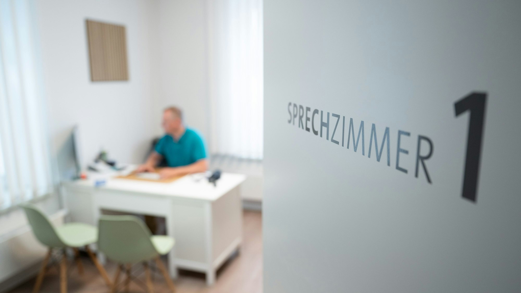 ILLUSTRATION - 27.05.2025, Sachsen, Dresden: Ein Hausarzt sitzt in einem Sprechzimmer seiner Hausarztpraxis an einem Schreibtisch und arbeitet am Computer. Digitalisierung und der Einsatz von Software spielen eine zunehmende Rolle im Praxisalltag von Hausärzten. (zu dpa: «Die freie Arztwahl wackelt») Foto: Sebastian Kahnert/dpa +++ dpa-Bildfunk +++