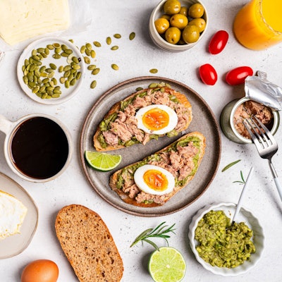 Frühstückstisch mit Zutaten und belegter Stulle.