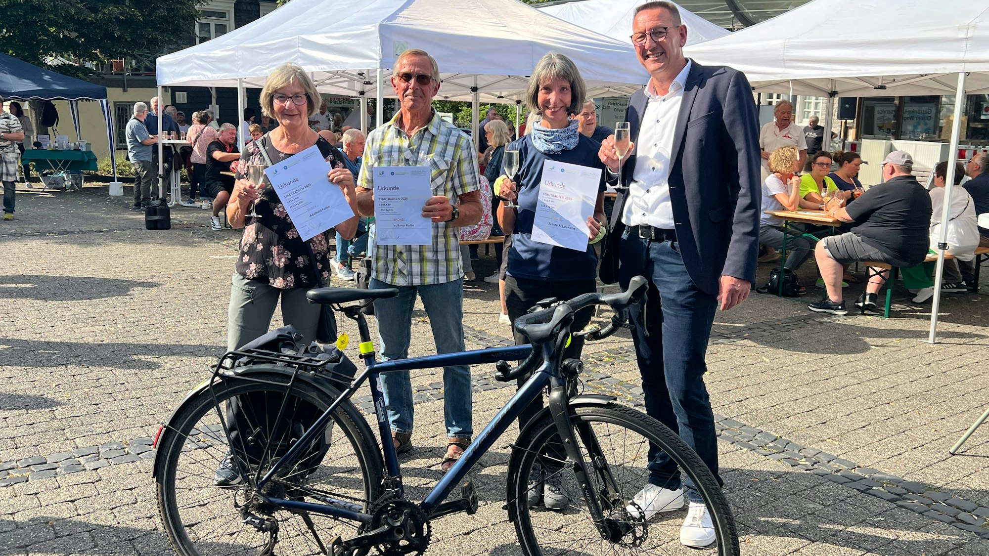 Bürgermeister Dirk Runge (r.) hat Adelheid Kolbe (zweiter Platz, v.l.) Volkmar Kolbe (dritter Platz) Sabine Krämer-Kox (erster Platz) für ihre Kilometer beim Stadtradeln ausgezeichnet.
