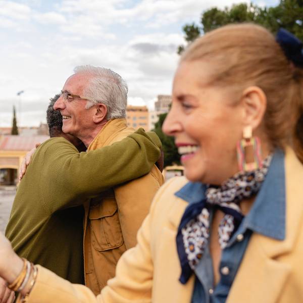 Senior friends socializing and hugging outdoors in an urban setting model released, Symbolfoto, JCCMF12883
