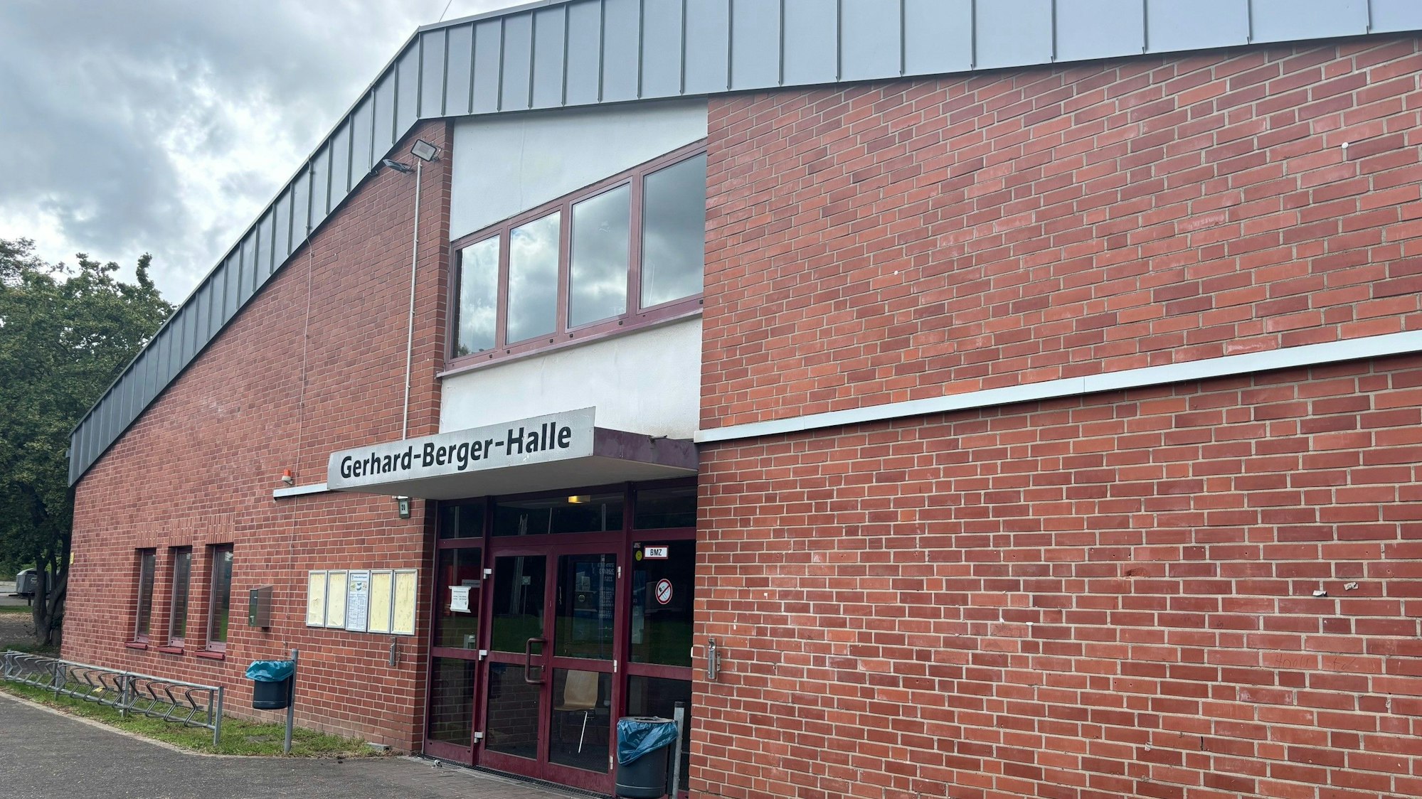 Auf dem Bild ist der Haupteingang einer Sporthalle zu sehen.