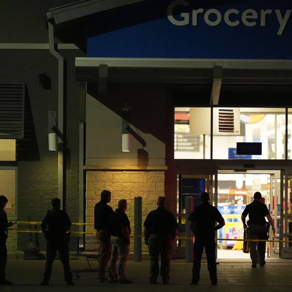 27.07.2025, USA, Traverse City: Polizeibeamte stehen vor einem Walmart, in dem in Traverse City, Michigan, 11 Menschen niedergestochen wurden. Foto: Ryan Sun/STF/dpa +++ dpa-Bildfunk +++