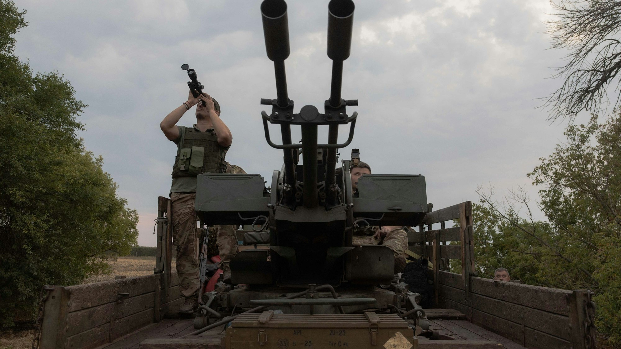 A Ukrainian serviceman of the 59th brigade mobile air defence unit monitors the sky from a military truck equipped with a Soviet made ZU-23 anti-aircraft twin autocannon during a Russian air attack near Pavlograd, Dnipropetrovsk region on July 18, 2025, amid the Russian invasion of Ukraine. Russia's deadly Geran drones, based on the Iranian technology, have been wreaking havoc on Ukraine since the beginning of the war three years ago. But since May 2026, they became more, with hundreds of drones now harassing cities and killing civilians almost daily. (Photo by Roman PILIPEY / AFP)