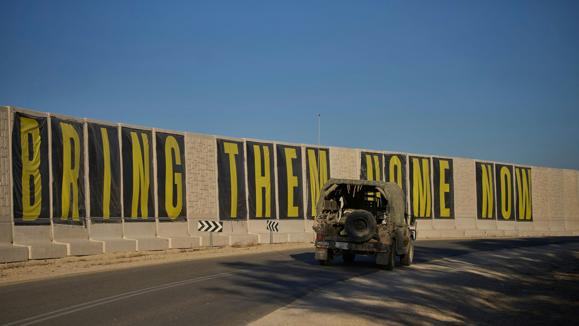 Ein Fahrzeug der israelischen Armee fährt in der Nähe der Grenze zwischen Israel und Gaza mit einem Transparent mit der Aufschrift ‚Bringt sie jetzt nach Hause‘ (Bring them home now), auf dem die Freilassung von Geiseln gefordert wird, die im Gazastreifen von der militanten Hamas-Gruppe festgehalten werden.