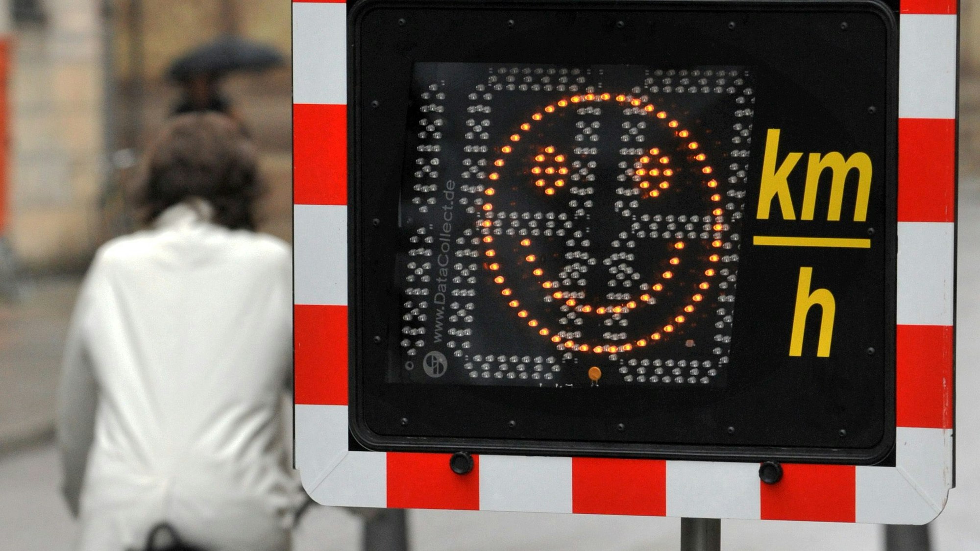 Ein Smiley auf einem elektronischer Zeigefinger zeigt einem Radfahrer am Mittwoch (24.06.2009) in der Residenzstraße in München (Oberbayern) an, dass er mit höchstens 15 Stundenkilometern unterwegs ist. Wer mit über 20 Stundenkilometern von der Polizei erwischt wird, muss ein Bußgeld von 20 Euro zahlen. Erlaubt sind in der Fußgängerzone 10 Stundenkilometer. Foto: Frank Leonhardt dpa/lby +++ dpa-Bildfunk +++