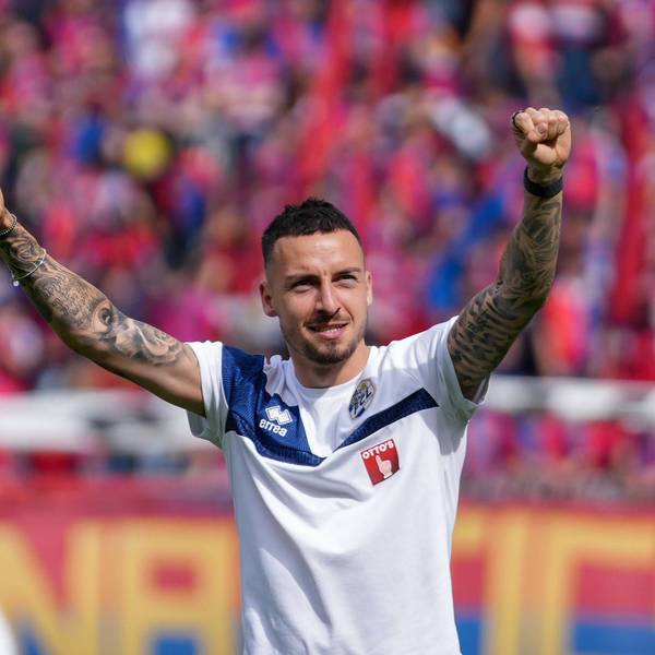 Fußballer Sinan Karweina streckt die Arme jubelnd in die Höhe.