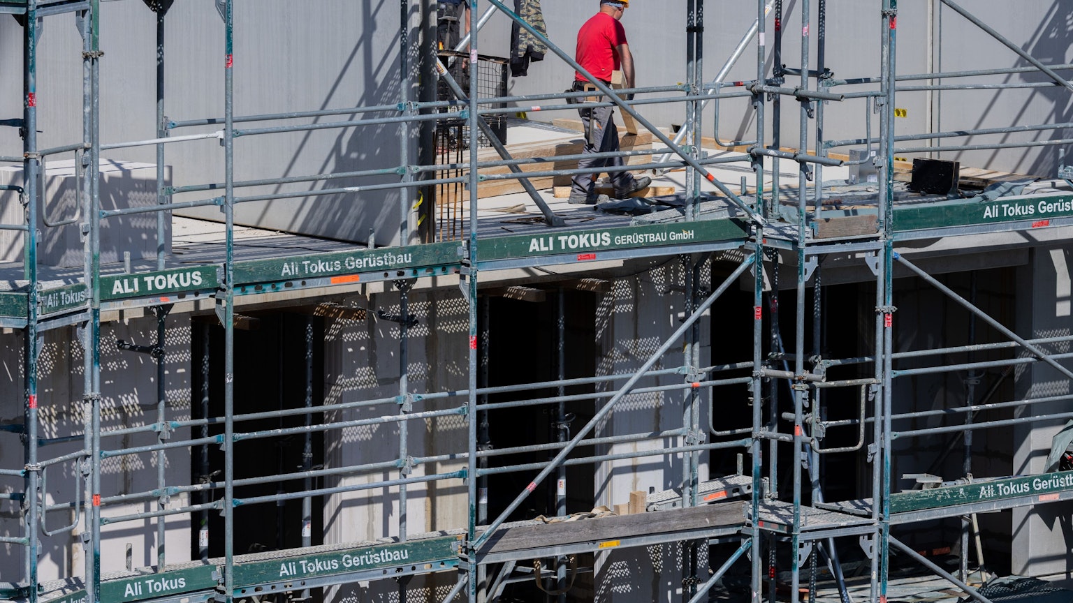 Bauarbeiter arbeiten an einem Rohbau für Eigentumswohnungen im Stadtteil Ehrenfeld.