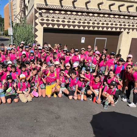 Das Foto zeigt eine große Gruppe von Schülerinnen und Schülern in rosafarbenen T-Shirts vor dem Phantasialand.