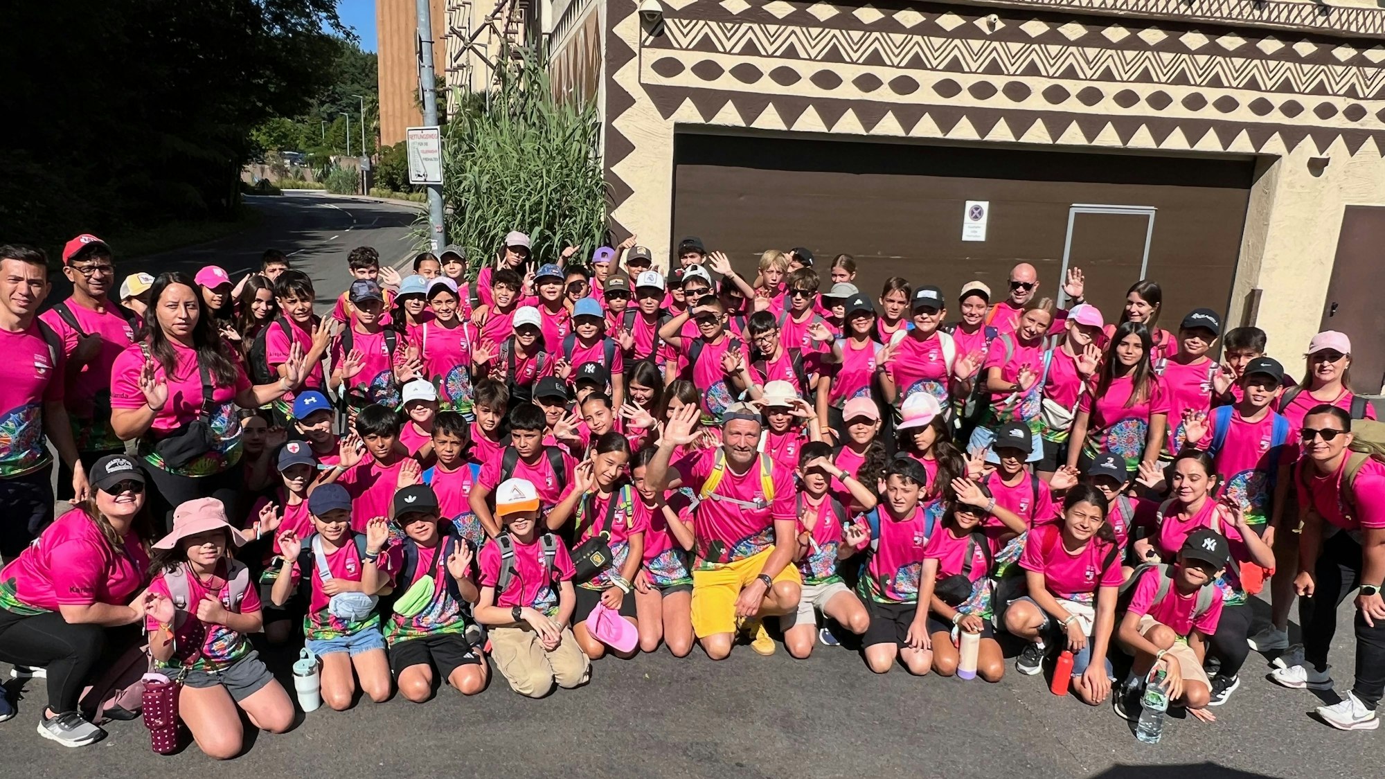 Das Foto zeigt eine große Gruppe von Schülerinnen und Schülern in rosafarbenen T-Shirts vor dem Phantasialand.