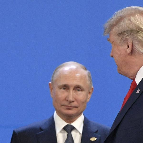 (FILES) US President Donald Trump (R) looks at Russia's President Vladimir Putin before posing for a family photo during the G20 Leaders' Summit in Buenos Aires, on November 30, 2018. US President Donald Trump said on August 8, 2025 he would meet with Russian counterpart Vladimir Putin on August 15 in Alaska, as the Republican billionaire hopes to help mediate an end to the war in Ukraine. (Photo by Juan Mabromata / AFP)