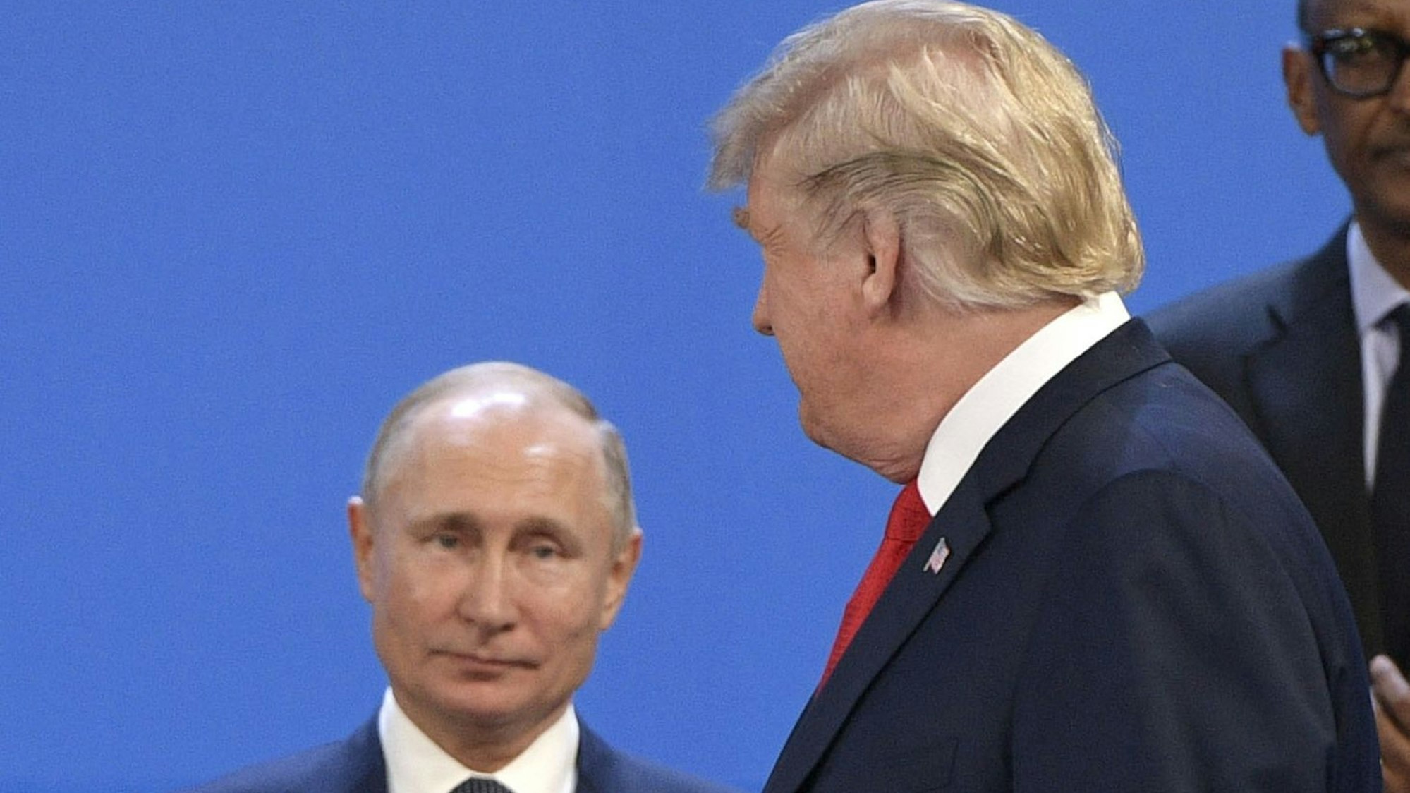 (FILES) US President Donald Trump (R) looks at Russia's President Vladimir Putin before posing for a family photo during the G20 Leaders' Summit in Buenos Aires, on November 30, 2018. US President Donald Trump said on August 8, 2025 he would meet with Russian counterpart Vladimir Putin on August 15 in Alaska, as the Republican billionaire hopes to help mediate an end to the war in Ukraine. (Photo by Juan Mabromata / AFP)