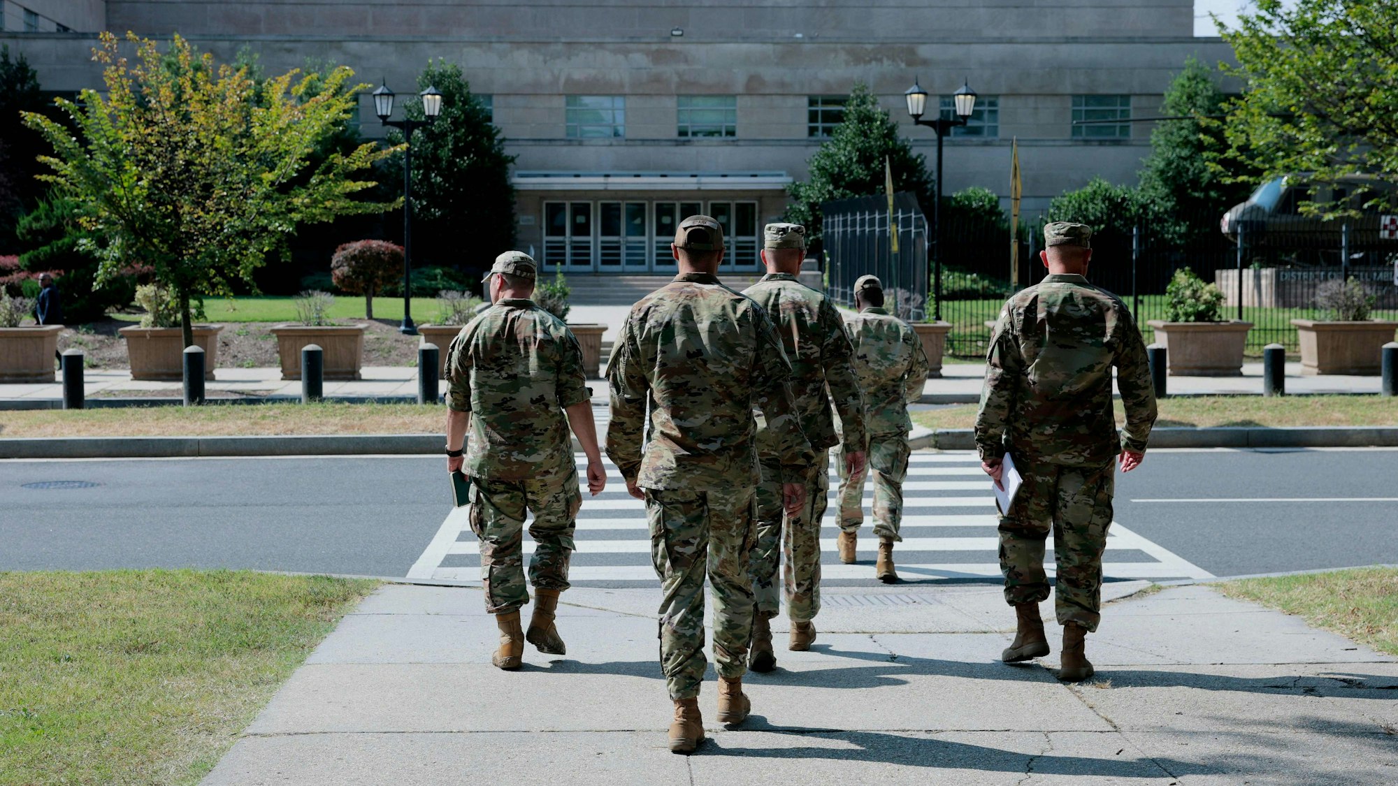 Soldaten überqueren einen Zebrastreifen.