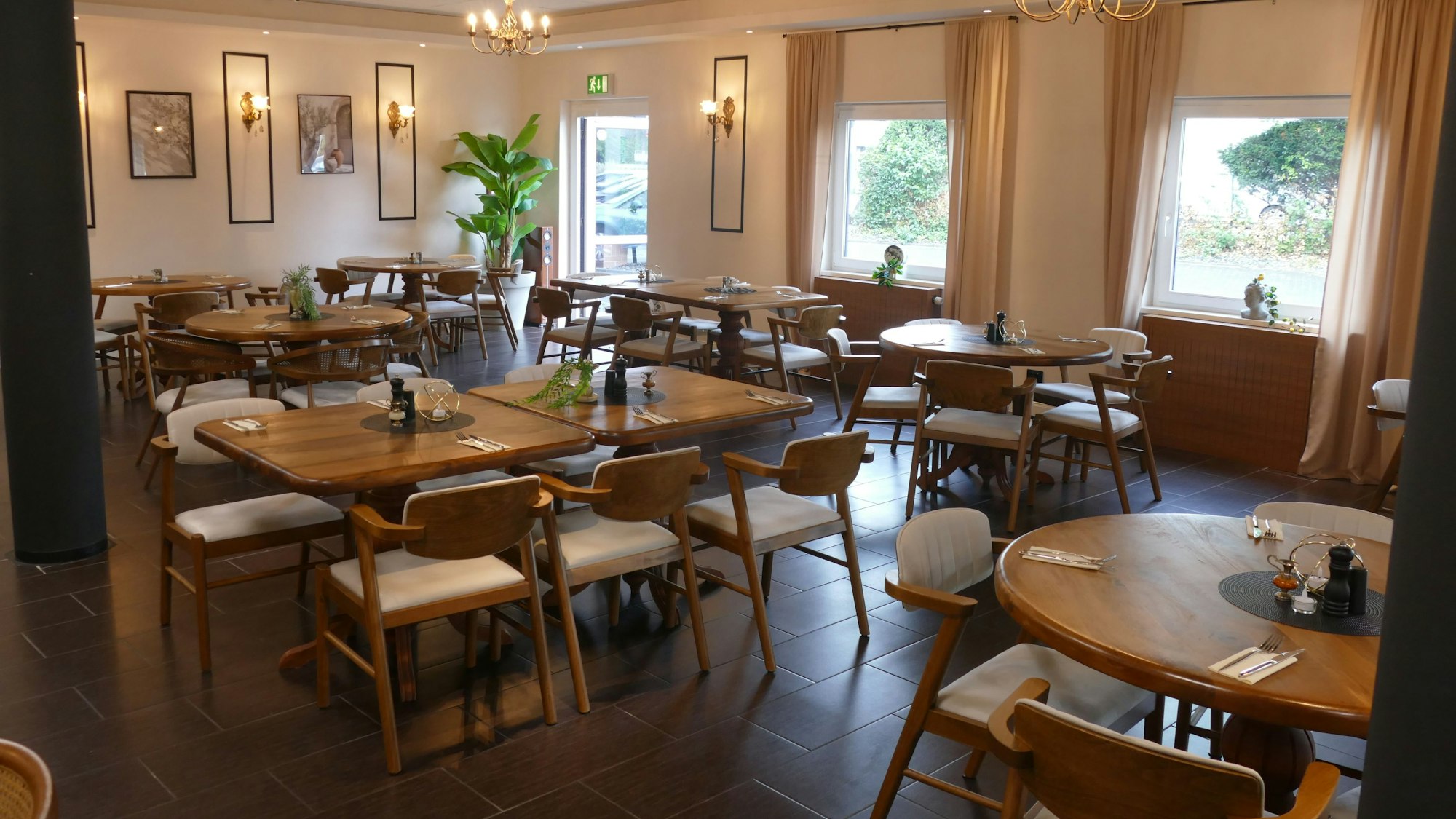 Der Innenraum des Restaurants mit Holztischen und Stühlen.