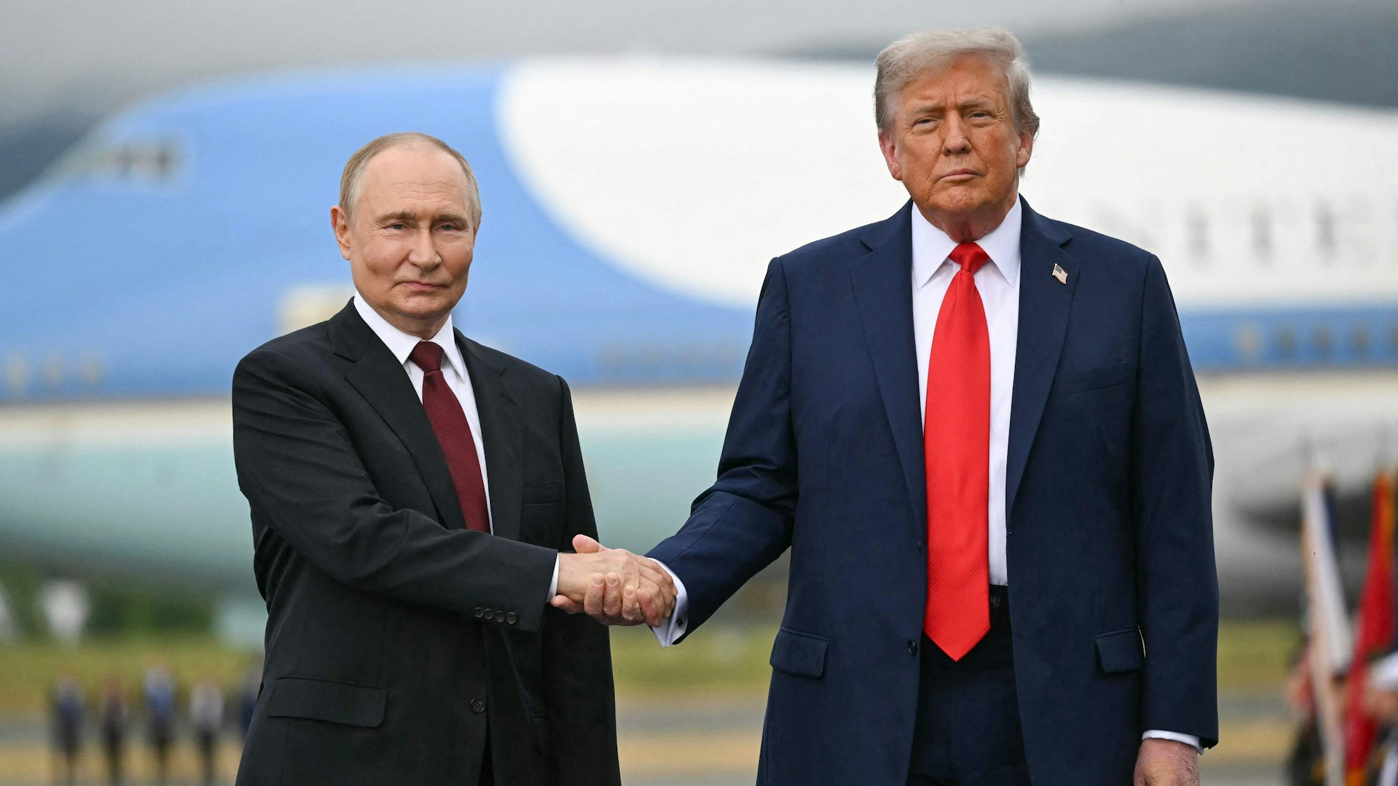 TOPSHOT - US President Donald Trump greets Russian President Vladimir Putin on the tarmac after they arrived at Joint Base Elmendorf-Richardson in Anchorage, Alaska, on August 15, 2025. Putin is in Alaska at the invitation of Trump in his first visit to a Western country since he ordered the 2022 invasion of Ukraine that has killed tens of thousands of people. (Photo by ANDREW CABALLERO-REYNOLDS / AFP)