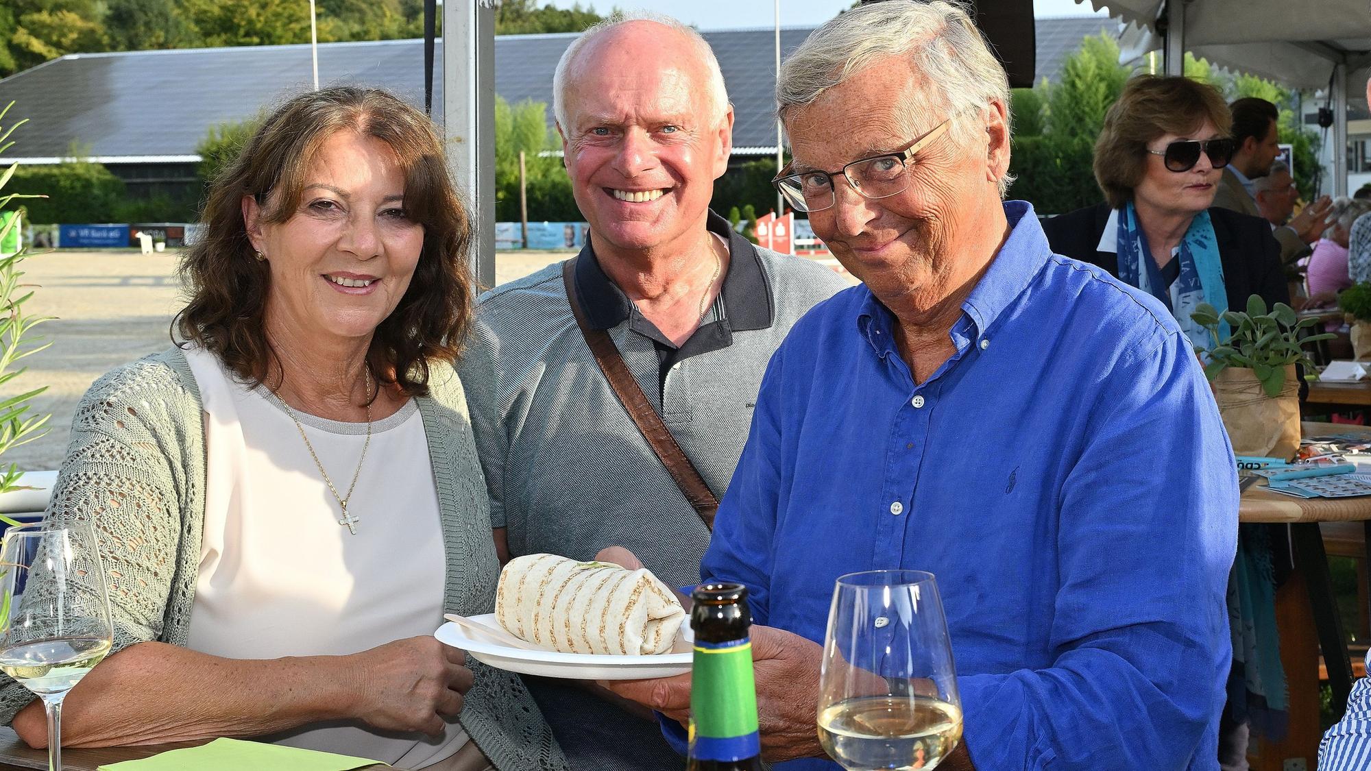 Sabine und Wolfgang Bosbach (r.) stehen mit Guido Maria Jansen aus Bensberg an einem Tisch beim Sommerfest der CU Rhein-Berg und Bergisch Gladbach.