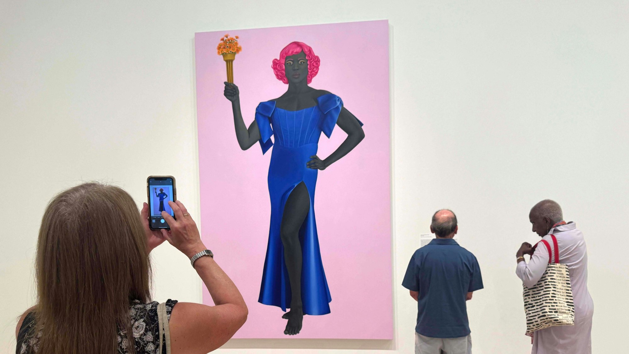 Besucher betrachten ein Gemälde im Museum.