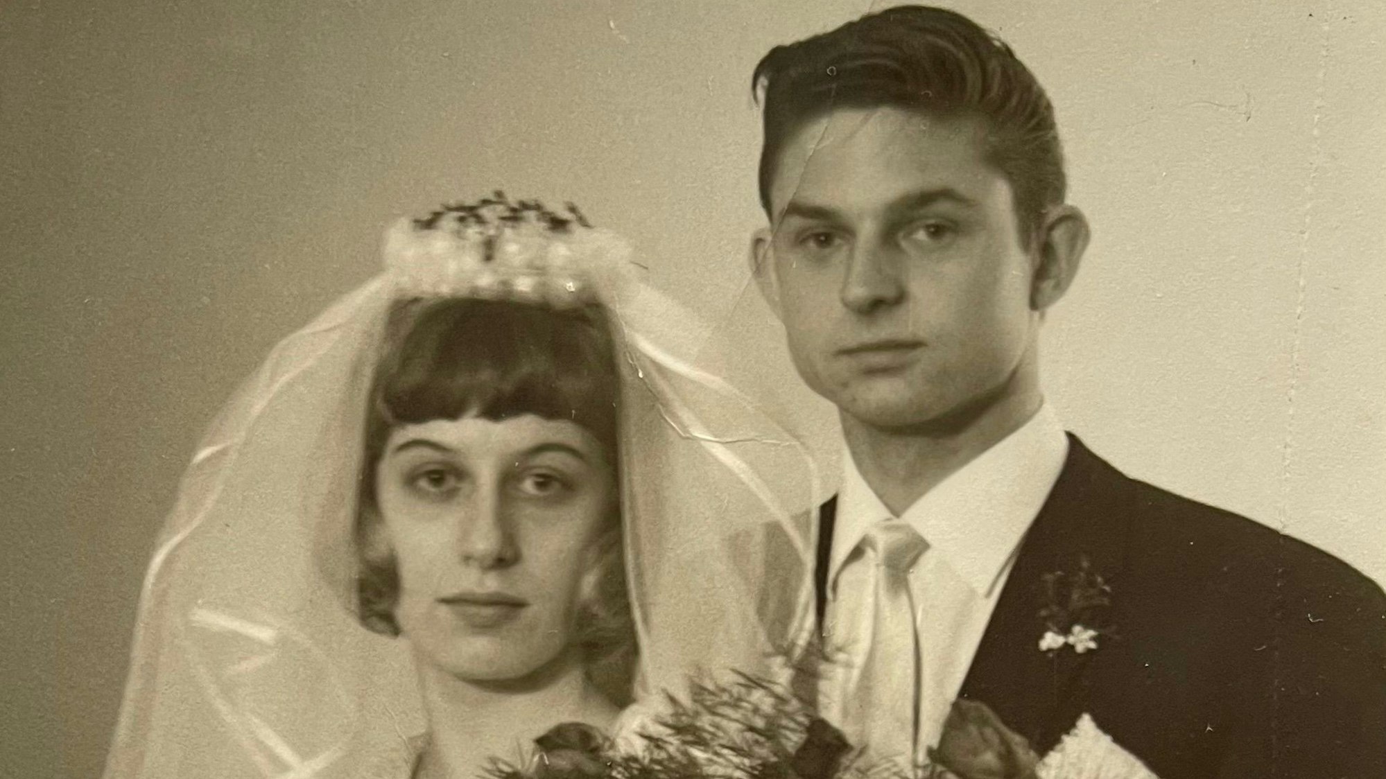 Ein junges Ehepaar vor über 60 Jahren an ihrer Hochzeit.
