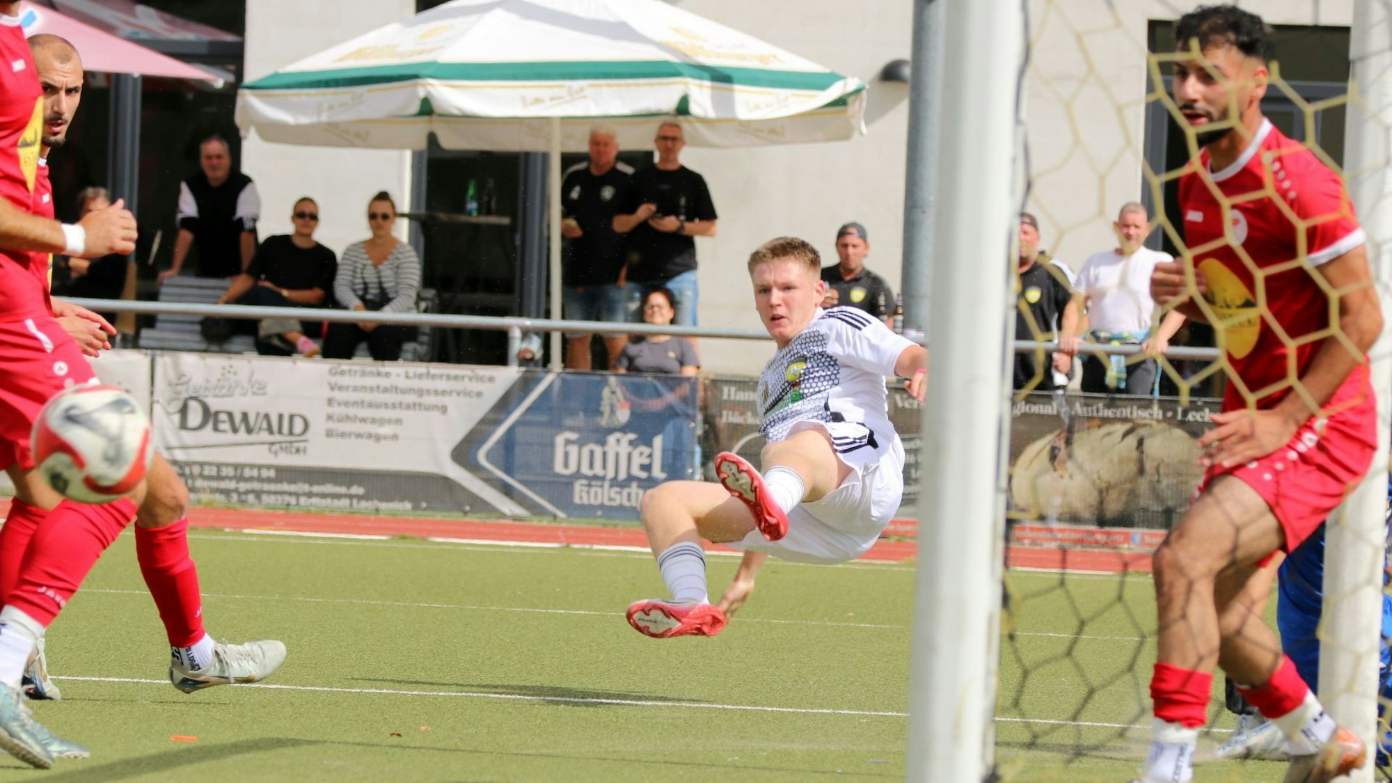 Ein Spieler von Erftstadt-Lechenich liegt quer in der Luft.