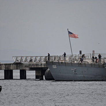 Crew members of the US Navy warship USS Sampson (DDG 102) are pictured at the Amador International Cruise Terminal in Panama City on September 02, 2025. Venezuelan President Nicolas Maduro said on September 1, 2025, that eight US military vessels with 1,200 missiles were targeting his country, which he declared to be in a state of "maximum readiness to defend" itself. (Photo by Martin BERNETTI / AFP)