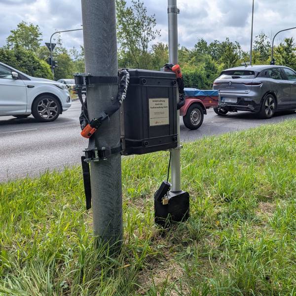 Das Foto zeigt ein Verkehrsmessgerät an einem Schildermast.