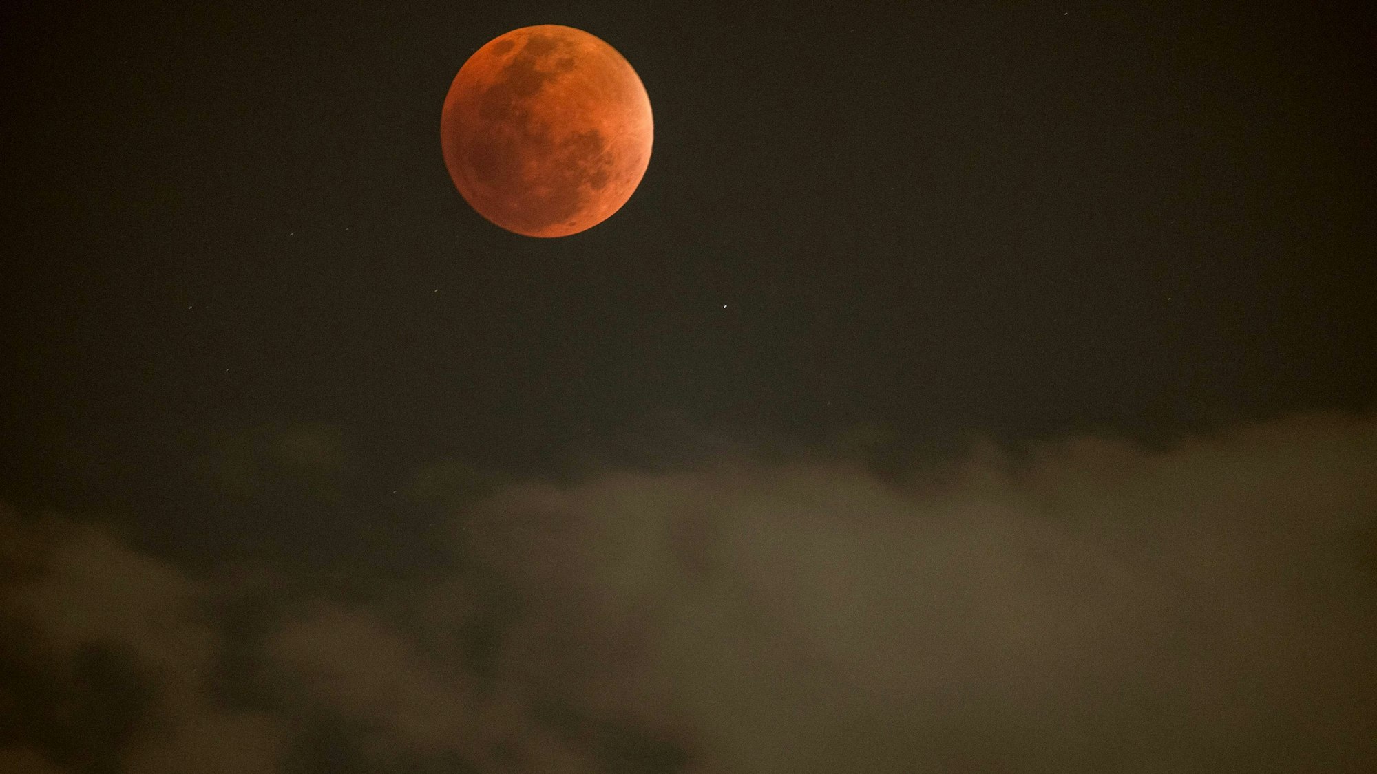This photograph shows the blood moon during a full lunar eclipse in Johannesburg on September 7, 2025. (Photo by Wikus de Wet / AFP)