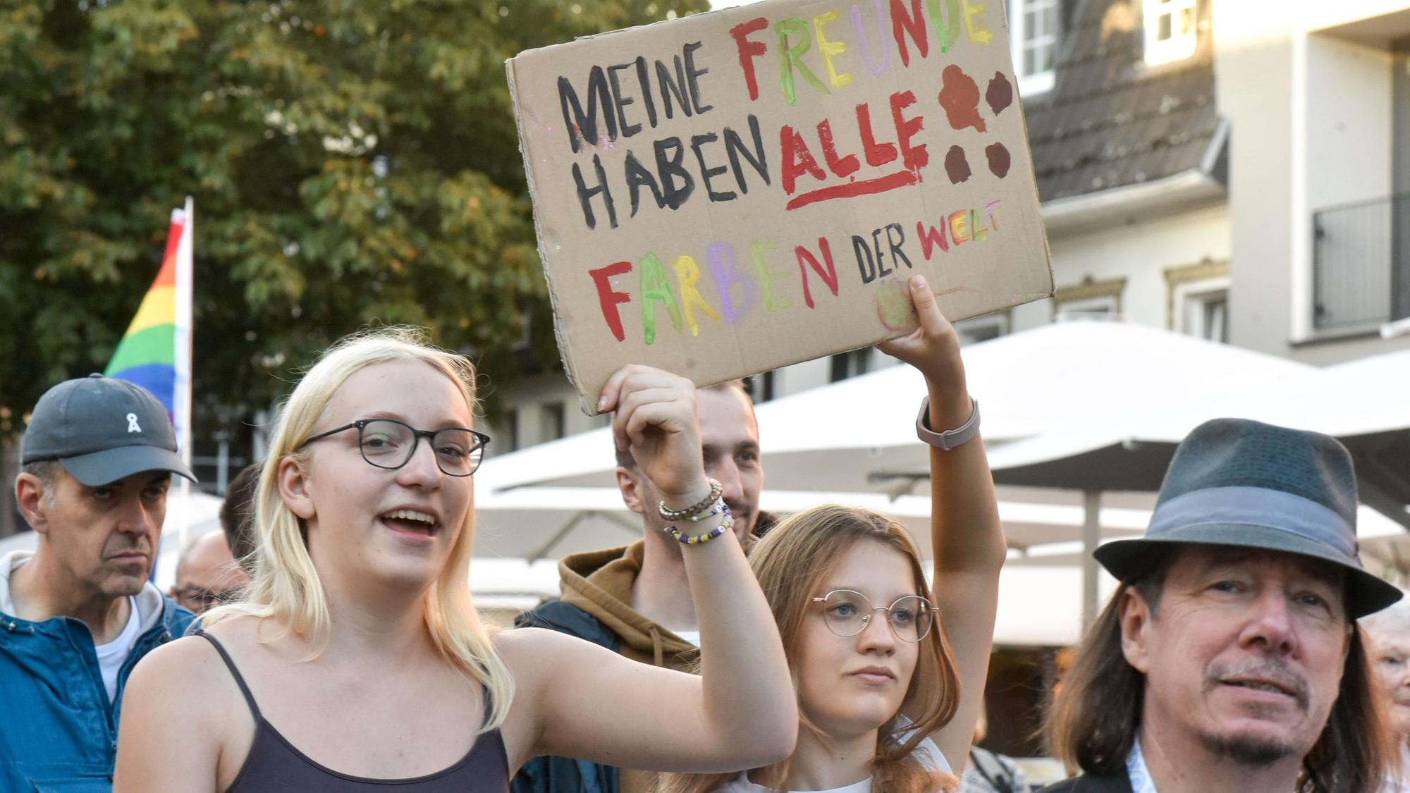 Auf dem Bild sind Demonstranten mit Pappschildern zu sehen.