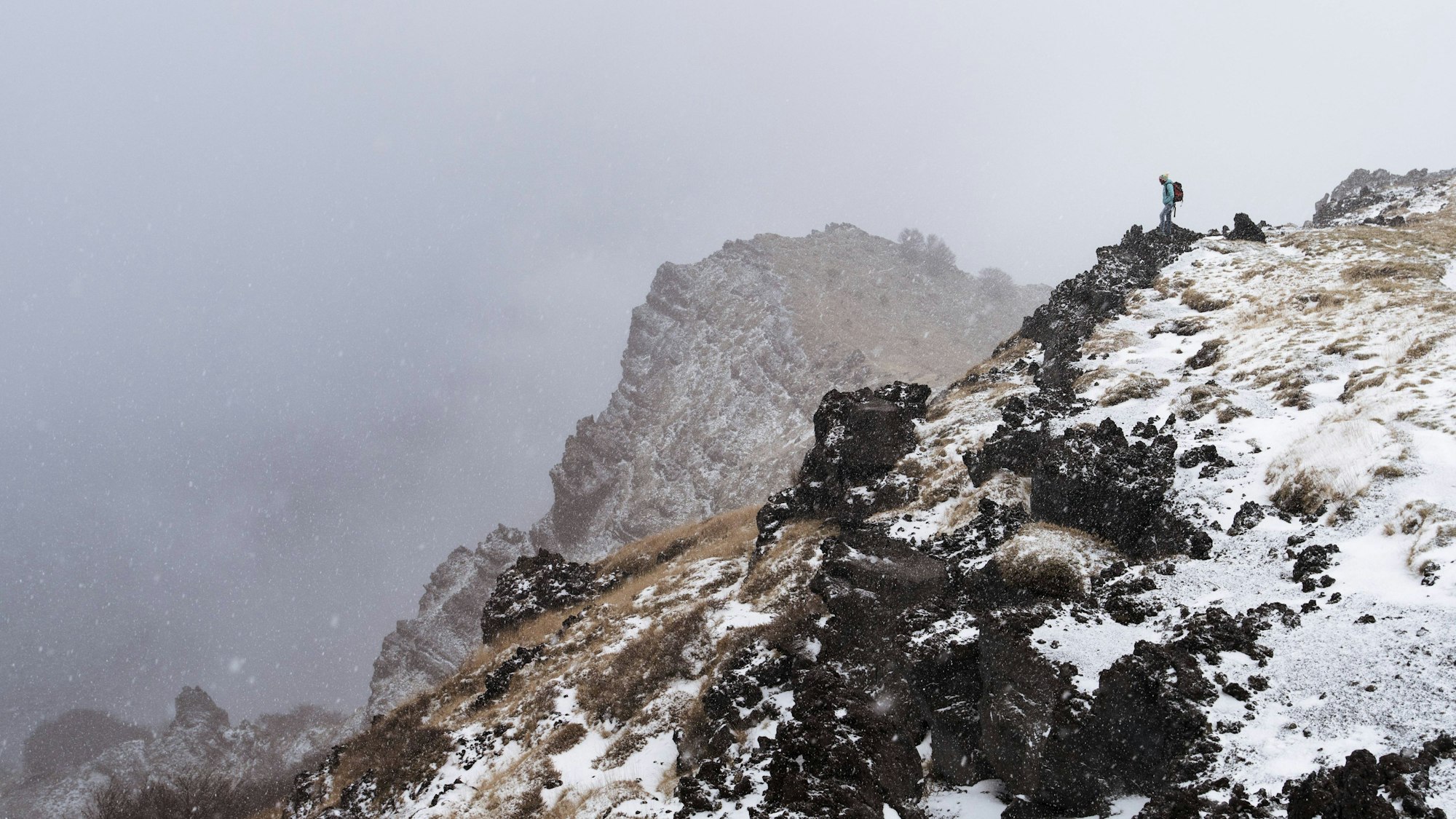 Fernblick auf eine Wanderin am Rande des Valle del Bove, Ätna.