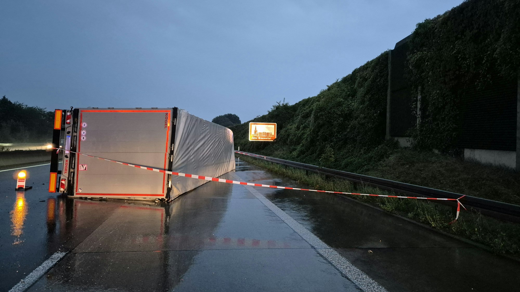 09.09.2025, Nordrhein-Westfalen, Frechen: Ein LKW liegt auf der regennassen Fahrbahn. Wegen eines umgestürzten Lastwagens gibt es auf der Autobahn 4 kilometerlange Staus. Foto: Sascha Thelen/dpa - ACHTUNG: Kfz Kennzeichen wurde aus rechtlichen Gründen gepixelt +++ dpa-Bildfunk +++