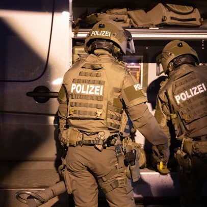 Beamte eines Spezialeinsatzkommandos (SEK) der Polizei agieren in einem Wohngebiet.