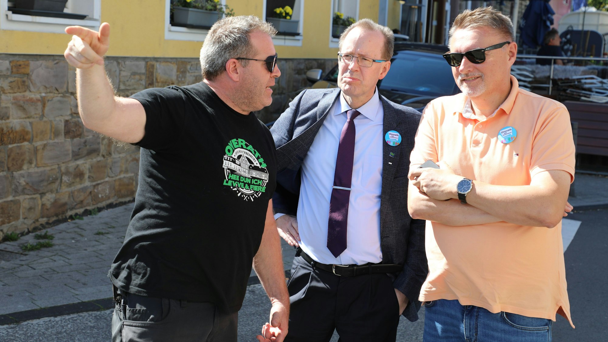 Die Stichwahlkandidaten Hans Schlömer (Mitte) und Michael Eyer lassen sich auf dem Overather Stadtfest den Notausgang zeigen.