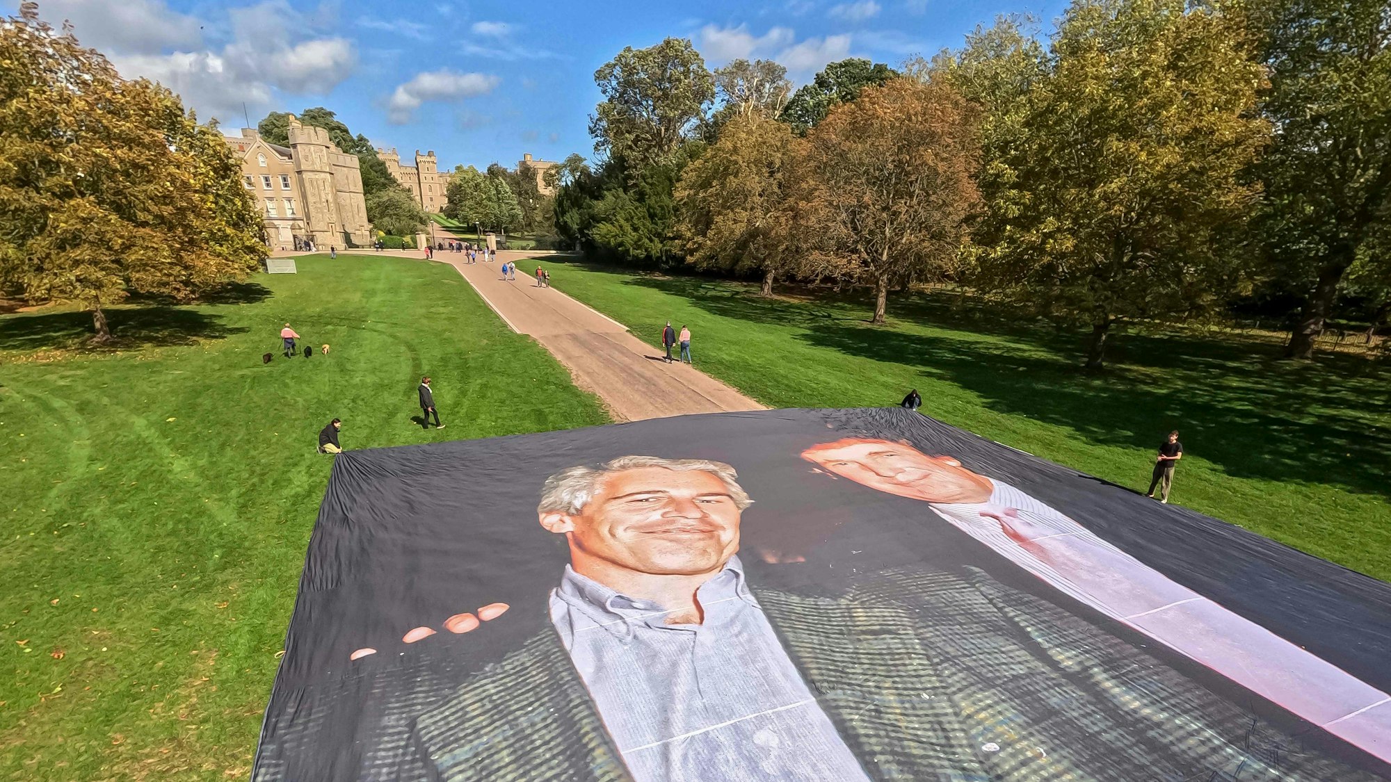 Aktivisten der Gruppe „Everyone Hates Elon“ zeigen vor Schloss Windsor ein großes Foto von Donald Trump mit Jeffrey Epstein.