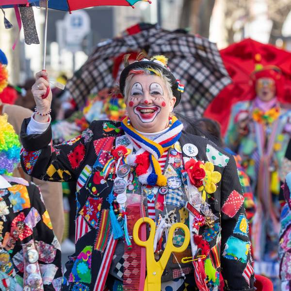 Als Clown verkleidete Jecke feiern.