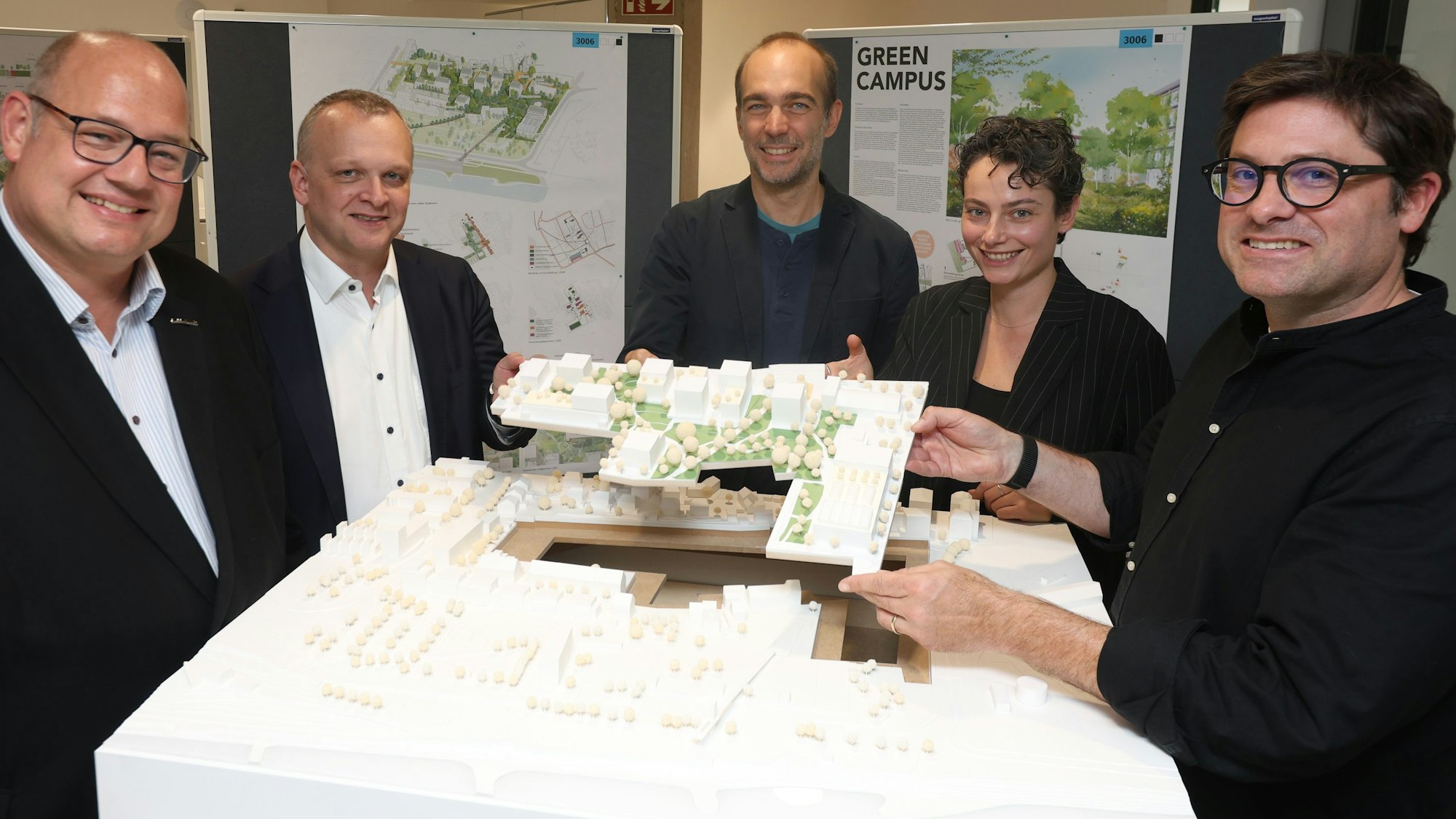 Levi-Aufsichtsrat Stefan Hebbel, Geschäftsführer Björn Krischick und Projektmanager Sascha Bender zeigen den Siegerentwurf für das Büroquartier an der Niederfeldstraße, den Andreas Krauth vom Büro Teleinternetcafé und Landschaftsarchitektin Katarina Mioc vom Büro Treibhaus verantworten.