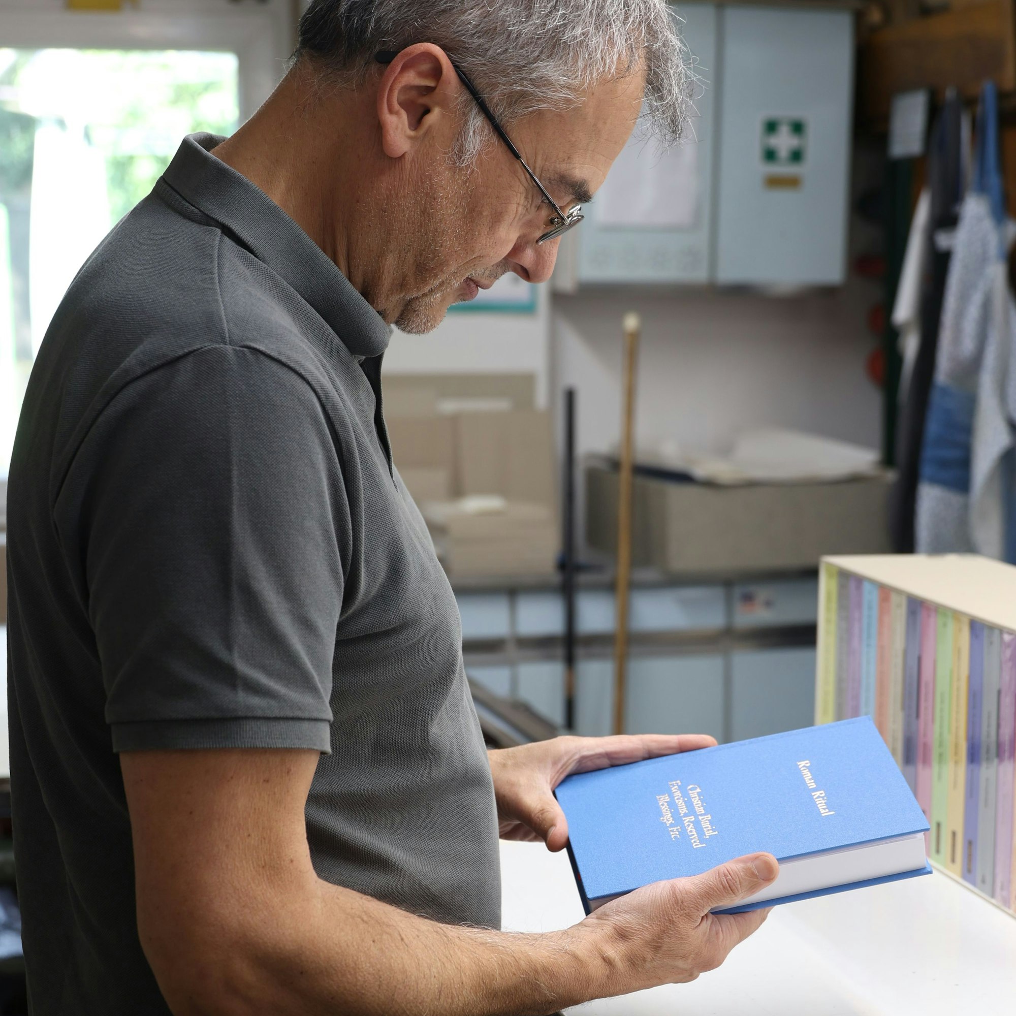 Ein Mann hält ein Buch in der Hand.