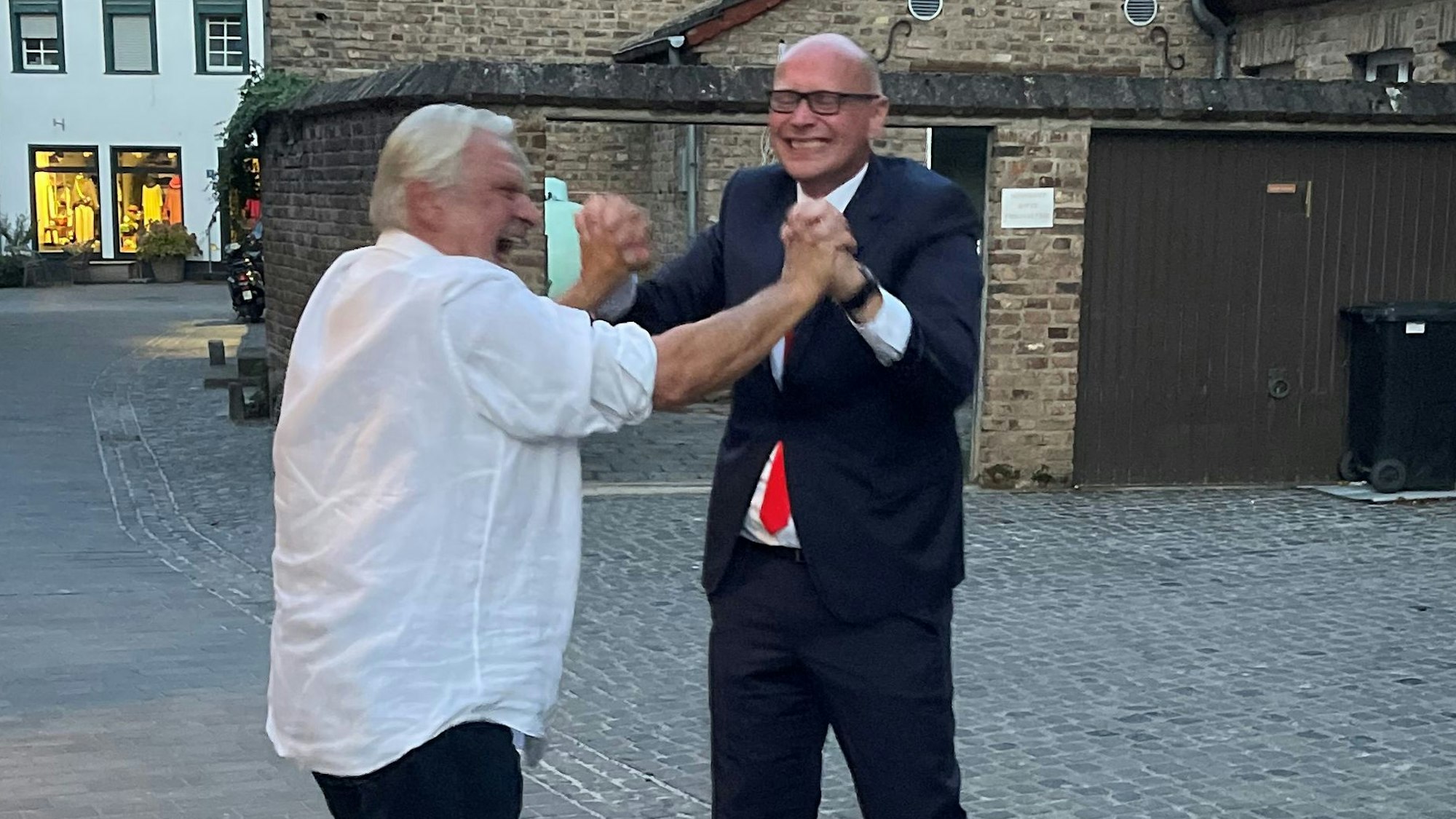 Zwei Männer jubeln gemeinsam über den Wahlsieg in Bad Münstereifel.